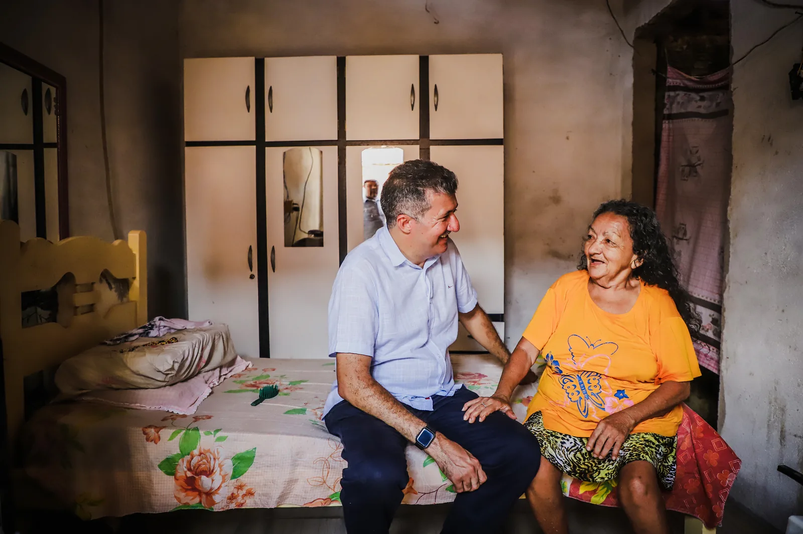 Antônio Henrique conversa com uma moradora dentro de casa, durante visita a uma família.